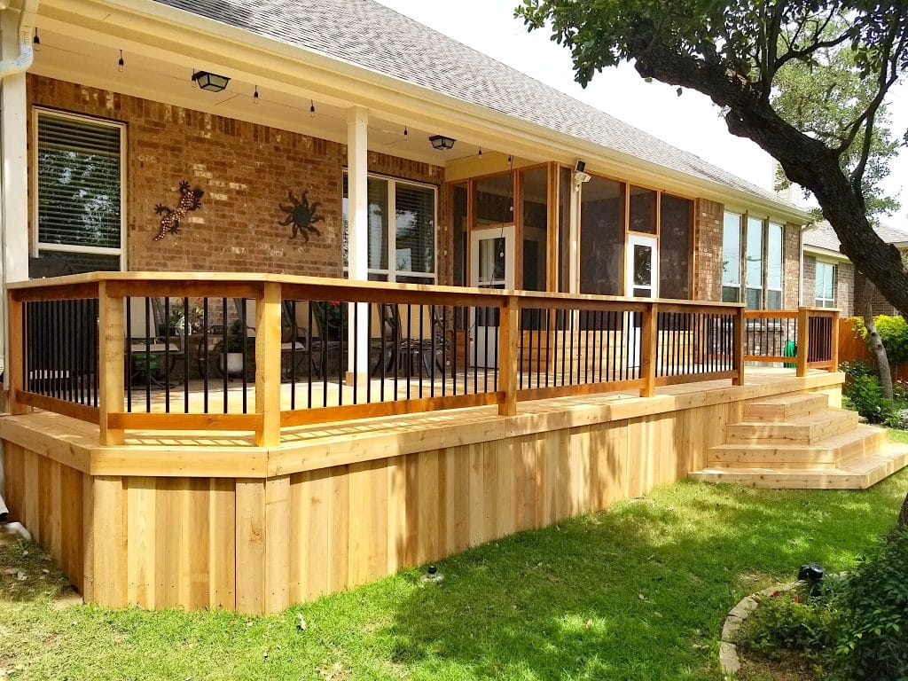 newly crafted wooden deck with wood railings and light wood steps